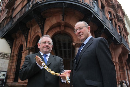 Newry-man Michael Hannaway is pictured handing over the chain of office to incoming RICS Northern Ireland Chairman, Paul Kendrick. Photograph: Press Eye